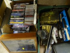 Box of DVDs and a box of miscellaneous items including vintage tins, rulers, cutlery etc