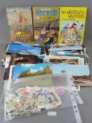 Quantity of vintage postcards, bag of unsorted loose stamps and three vintage Enid Blyton children's