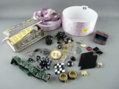 White metal casket of unsorted stamps and a floral topped circular box containing a quantity of