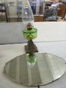 Vintage bevelled edge mirror and a glass font oil lamp with cast iron base