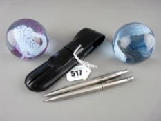 Parker stainless steel ballpoint pen and pencil set in case and two Caithness glass paperweights