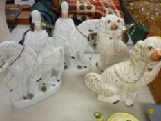 Pair of Staffs flatback figures on horseback and a pair of white and gilt decorated comforter dogs