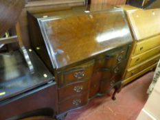 Polished wood writing bureau with three shaped and graduated drawers