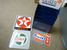 Quantity of motor oil advertising signs and a National Savings pamphlet rack