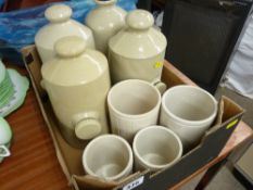 Four stoneware hot water bottles and four vintage Hartleys jars
