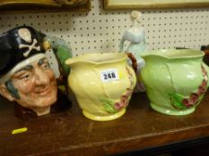 Royal Doulton 'Long John Silver' character jug, two Carltonware Green Leaf type jugs and a