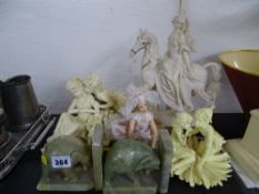 Pair of onyx elephant bookends with a quantity of figural ornaments and a seated doll