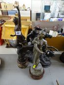 Spelter horse and rider and two standing figurines on circular bases