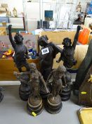 Five various cast metal figurines on circular wooden bases