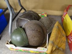 Four vintage military tin hats and one other along with a broad arrow marked inflatable exposure