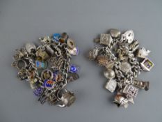 Two silver charm bracelets with padlock clasps, one having twenty five, the other fifteen silver and