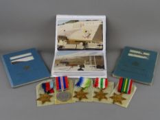 Group of five unmarked Second World War medals with award paperwork, seaman's record book and