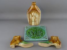 Victorian Majolica wall tile, two slip glazed moneybox boots and a Victoria and Albert slip glazed