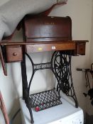 A vintage treadle Singer sewing machine on cast metal stand