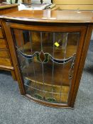 A mahogany & bow fronted hanging display cabinet with a leaded stain glass door
