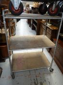 A vintage metal framed three-tier hospital-style trolley