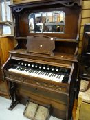 An early twentieth century Waddington & Sons mahogany cased harmonium with a mirrored upper section