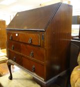 A vintage mahogany drop down bureau on raised ball & claw feet