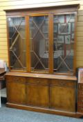 A reproduction mahogany astragal glazed top cupboard bookcase