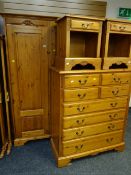 A good pine bedroom suite comprising three-door wardrobe, tall chest of drawers, bedside cabinets,