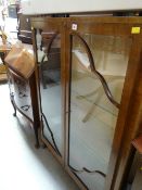 A vintage oak two-door display cabinet