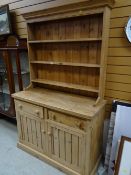A stripped pine kitchen dresser