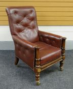 A good William IV English library chair in red button and studded leather with deep seat, carved