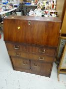 A vintage mahogany narrow drop front bureau with drawer & cupboard base