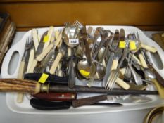 A tray of mixed flatware