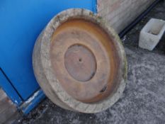 A stone circular floor standing planter (outside)