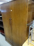A vintage oak bedroom suite comprising two-door wardrobe, mirrored dressing table & a gentleman's