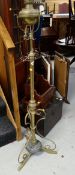 A brass & metal adjustable columned oil lamp converted to electric