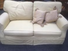 Two-seater sofa in gold coloured upholstery