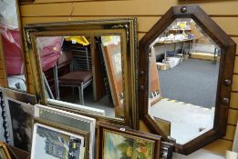A modern gilt effect wall mirror together with a vintage octagonal oak framed wall mirror