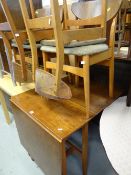 A 1960s lightwood drop leaf dining table together with four butterfly beechwood cushion seat
