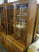 A modern lightwood lounge unit comprising glazed upper & cupboard base