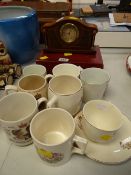 A small inlaid mantel clock, boxed EPNS cruet set, royal commemorative ware