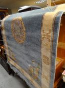 A pair of Lahore blue & fawn Oriental decorated silk rugs