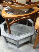 A G-Plan style teak circular glass top coffee table together with a painted grey octagonal glass top