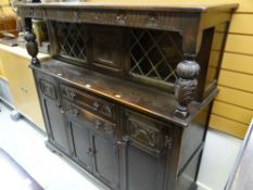 A Stanley Wood dark oak court cupboard