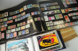 Large parcel of modern loose stamps together with an album of postcards