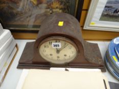 A vintage mahogany dome top mantel clock