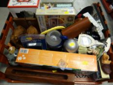 Crate of mixed household items including jigsaw puzzles, carved wooden elephant bookends, frames