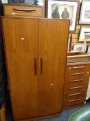 A vintage G-Plan bedroom suite comprising double wardrobe, mirrored dressing table & stool, low &