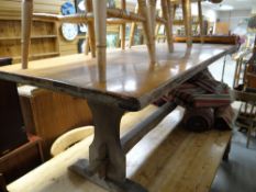 A large oak plank top refectory-style dining table (in need of some restoration)