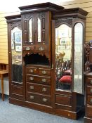 An impressive Edwardian breakfront two-door mirror wardrobe / compactum with central cupboards &