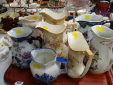Tray of various patterned Staffordshire jugs including a graduated set & a Royal Doulton Norfolk