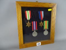 Cased group of four World War II medals (appear unmarked where visible)