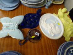 Three decorative wall ornaments, a blue glass hen eggholder and a studio glass ornament