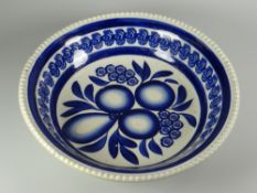 A LLANELLY POTTERY SPONGE WARE BOWL with moulded border and decorated in blue with centred fruit and
